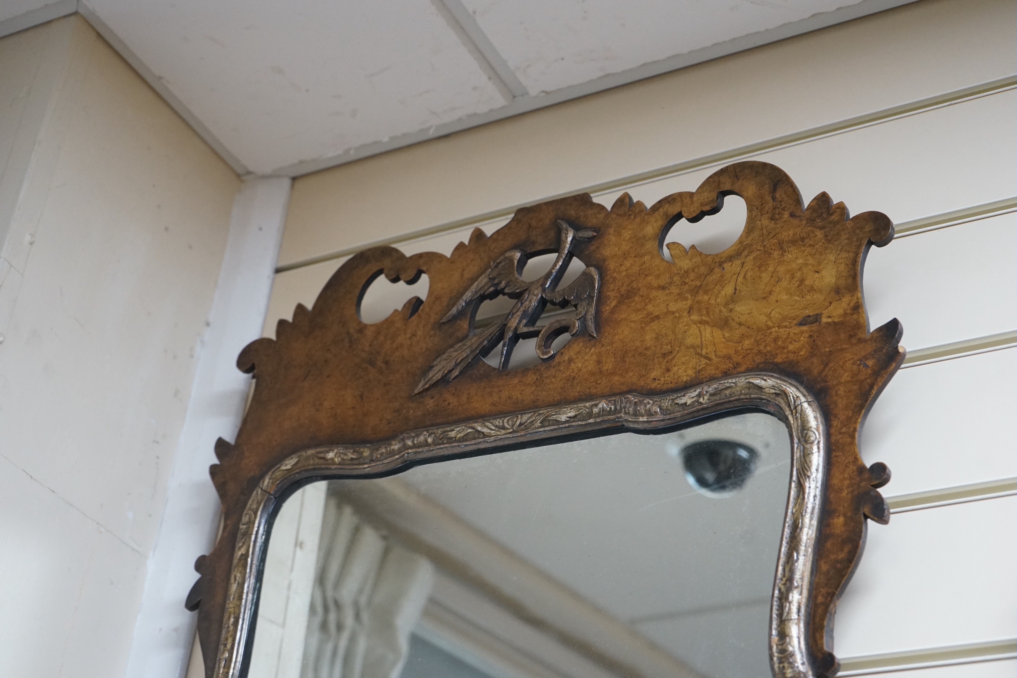 An 18th century style walnut fret cut wall mirror width 43cms height 93cms